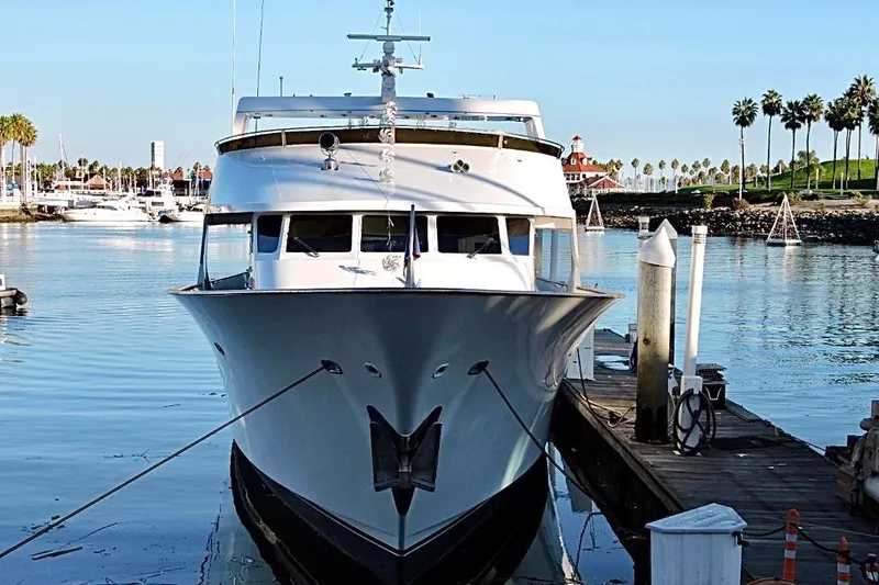 Slide: The Image of Luxurious 1992 Christensen motor yacht docked under clear blue sky. - 5