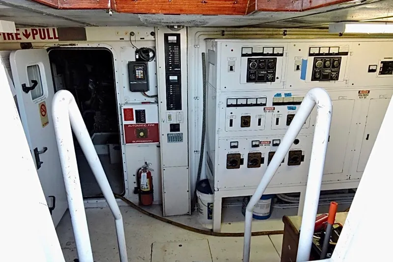 Slide: The Image of Engine room of 1992 Christensen motor yacht with complex machinery and control panel. - 51