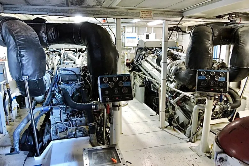 Slide: The Image of Engine room of 1992 Christensen Motor Yacht, showcasing mechanical components and wiring. - 52