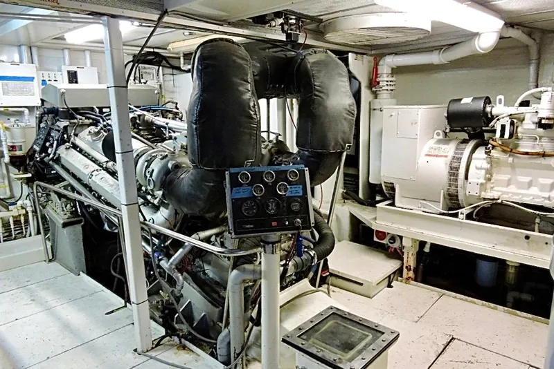 Slide: The Image of Engine room of 1992 Christensen Motor Yacht with complex piping and control panels. - 53