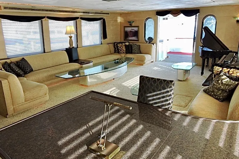 Slide: The Image of Luxurious 1992 Christensen motor yacht interior with elegant seating, glass tables, and a grand piano. - 7