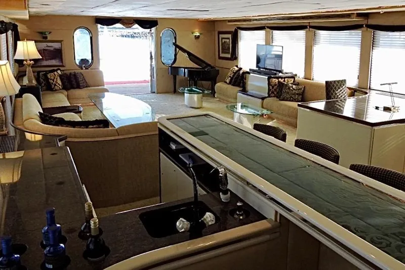 Slide: The Image of Luxurious 1992 Christensen motor yacht interior with elegant seating, bar, and grand piano. - 8