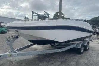The Image of 2021 Hurricane SunDeck Sport 192 RL OB boat on trailer, parked outdoors. - 0