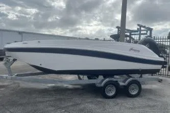 Slide: The Image of 2021 Hurricane SunDeck Sport 192 RL OB boat on trailer, parked outdoors. - 1