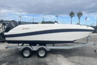 Slide: The Image of 2021 Hurricane SunDeck Sport 192 RL OB boat on trailer, parked outdoors. - 2