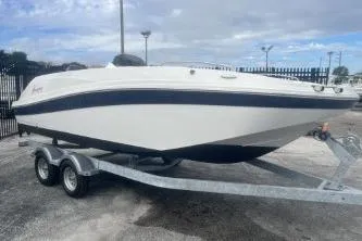 Slide: The Image of 2021 Hurricane SunDeck Sport 192 RL OB boat on trailer, parked outdoors. - 3