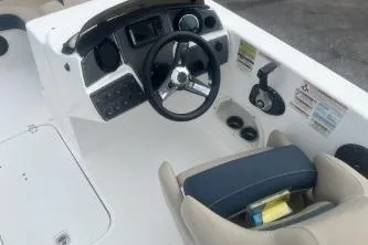 Slide: The Image of 2021 Hurricane SunDeck Sport 192 RL OB boat cockpit with steering wheel and seating. - 7