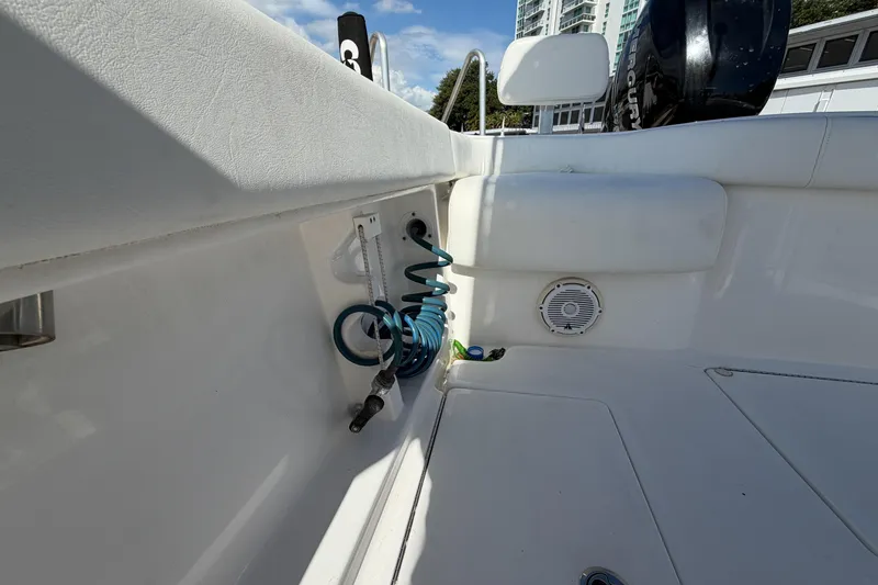 Slide: The Image of Interior of a 2016 Contender 24 Sport boat with coiled hose and speaker. - 11