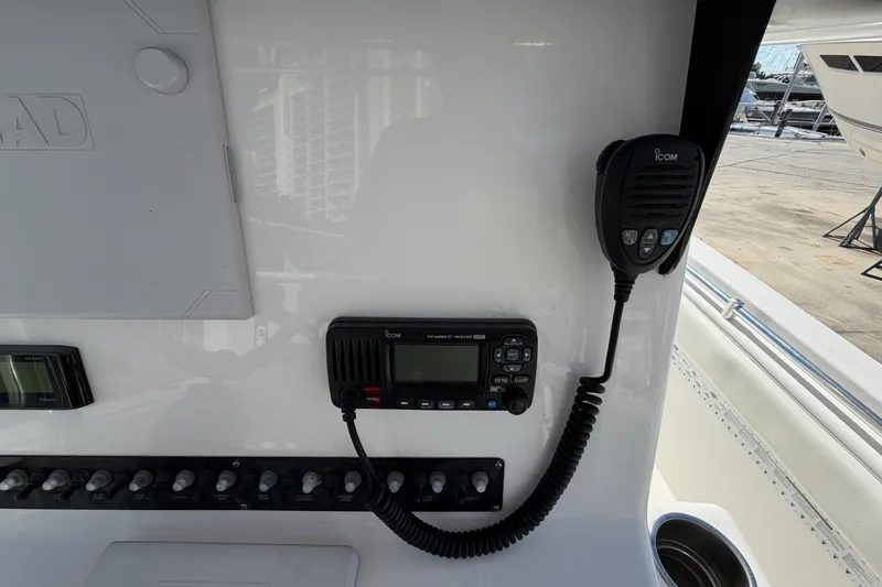 Slide: The Image of 2016 Contender 24 Sport boat dashboard with Icom radio and control panel. - 15