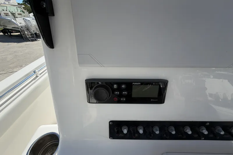 Slide: The Image of 2016 Contender 24 Sport boat dashboard with Fusion MS-RA70 stereo system and control panel. - 16
