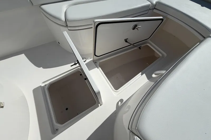 Slide: The Image of 2016 Contender 24 Sport boat storage compartments with open hatches, showcasing interior space. - 20