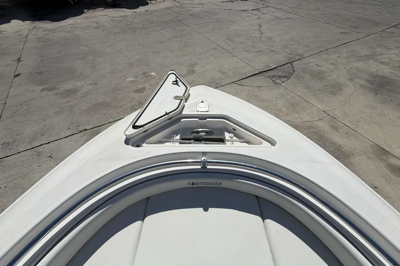 Slide: The Image of Bow of 2016 Contender 24 Sport boat on concrete surface. - 21