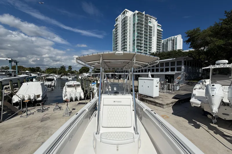 Slide: The Image of 2016 Contender 24 Sport boat docked at marina with high-rise buildings in background. - 24