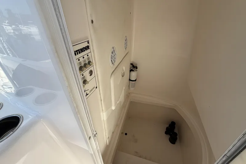 Slide: The Image of Interior of a 2016 Contender 24 Sport boat, featuring control panel and storage area. - 25