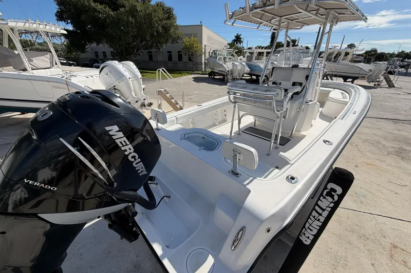 Slide: The Image of 2016 Contender 24 Sport boat with Mercury Verado engine, docked outdoors. - 7