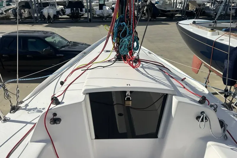 Slide: The Image of 2016 J Boats J/70 sailboat deck with colorful rigging in a marina setting. - 13