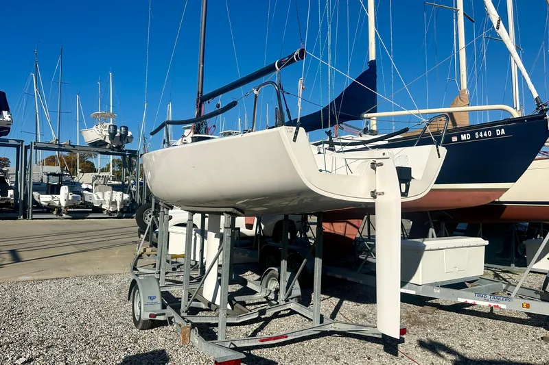 Slide: The Image of 2016 J Boats J/70 sailboat on trailer in marina, surrounded by other boats. - 4