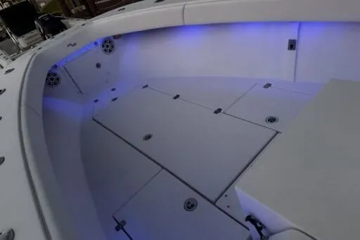 Slide: The Image of 2006 SeaVee 260 boat interior with blue LED lighting and spacious deck layout. - 4