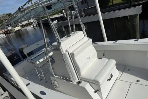 Slide: The Image of 2006 SeaVee 260 boat with white seating and console, docked in a marina. - 6