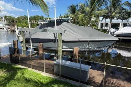 Slide: The Image of Covered 2006 SeaVee 260 boat docked by palm trees and waterfront homes. - 7