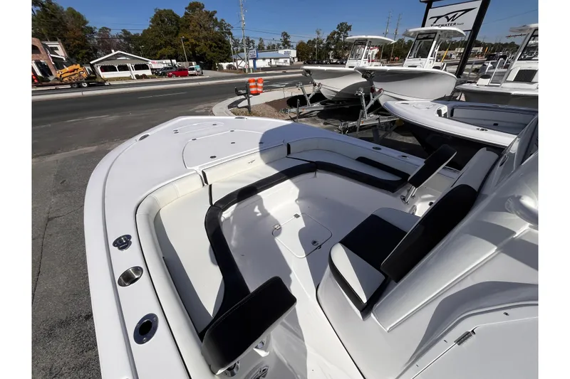 Slide: The Image of 2026 Tidewater 2500 Carolina Bay boat interior with seating, displayed outdoors. - 11