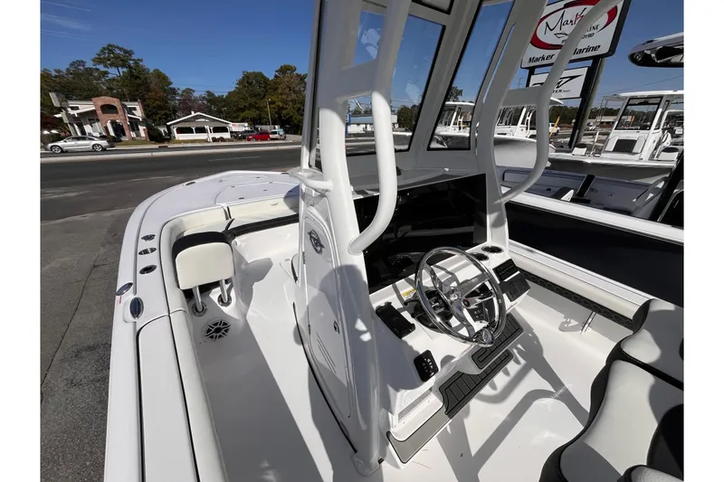 Slide: The Image of 2026 Tidewater 2500 Carolina Bay boat interior with steering wheel and seating. - 13