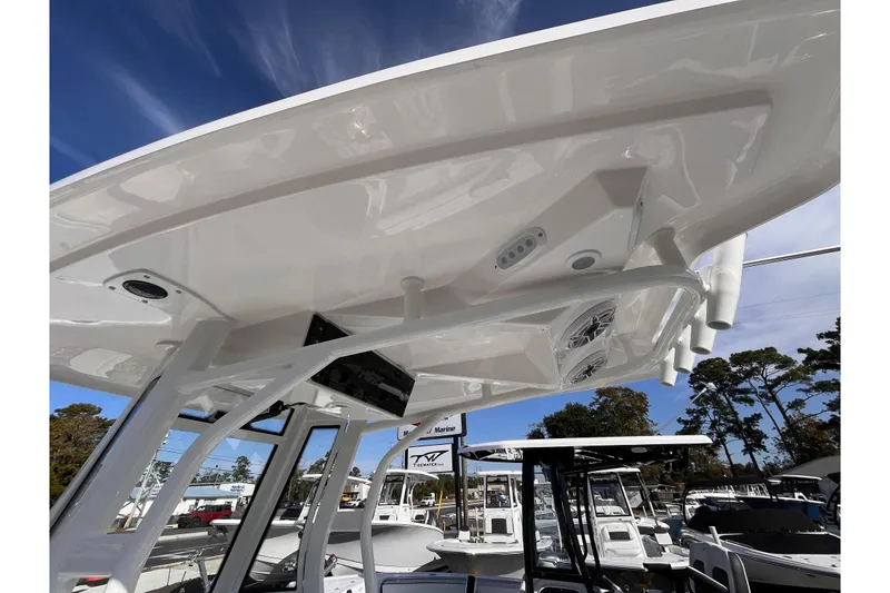 Slide: The Image of 2026 Tidewater 2500 Carolina Bay boat with T-top and rod holders, viewed from below. - 14