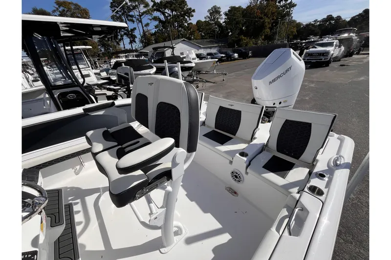 Slide: The Image of 2026 Tidewater 2500 Carolina Bay boat interior with seating and Mercury engine. - 15