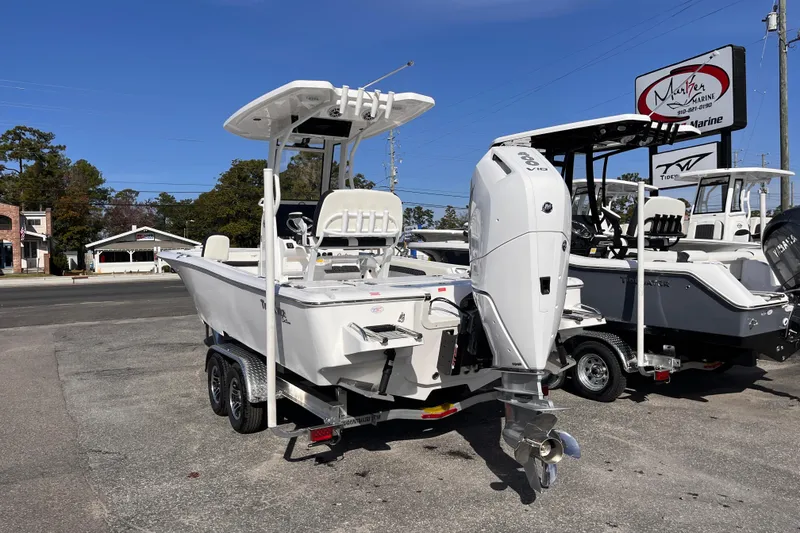 Slide: The Image of 2026 Tidewater 2500 Carolina Bay boat on trailer, displayed outdoors at a dealership. - 2
