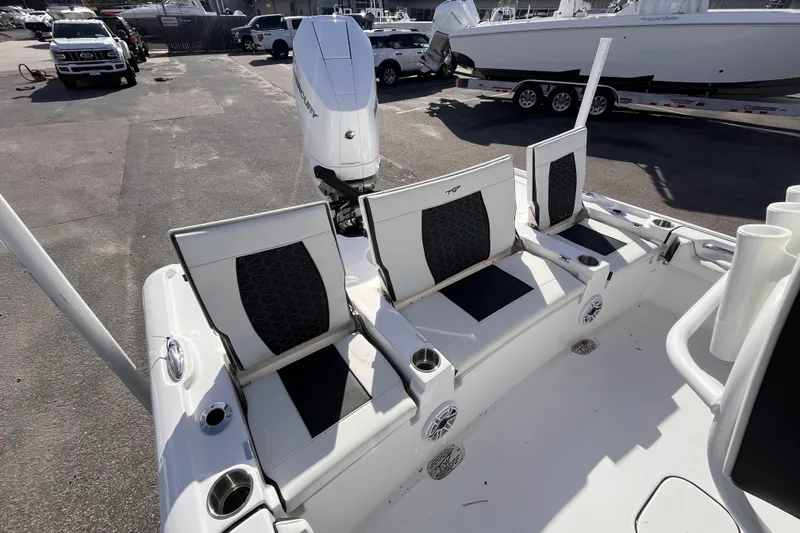 Slide: The Image of 2026 Tidewater 2500 Carolina Bay boat with seating and motor, parked outdoors. - 5