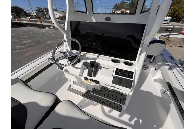 Slide: The Image of 2026 Tidewater 2500 Carolina Bay boat console with steering wheel and control panel. - 7