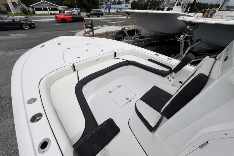 Slide: The Image of 2026 Tidewater 2500 Carolina Bay boat interior with white and black seating. - 12