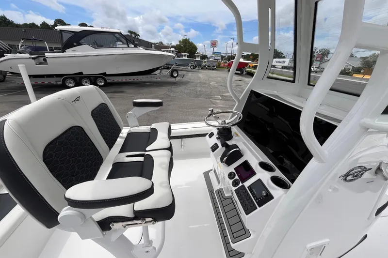 Slide: The Image of 2026 Tidewater 2500 Carolina Bay boat interior with modern helm and seating. - 16