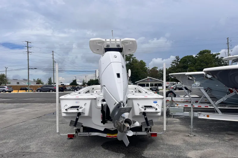 Slide: The Image of 2026 Tidewater 2500 Carolina Bay boat with outboard motor, parked on a trailer. - 3