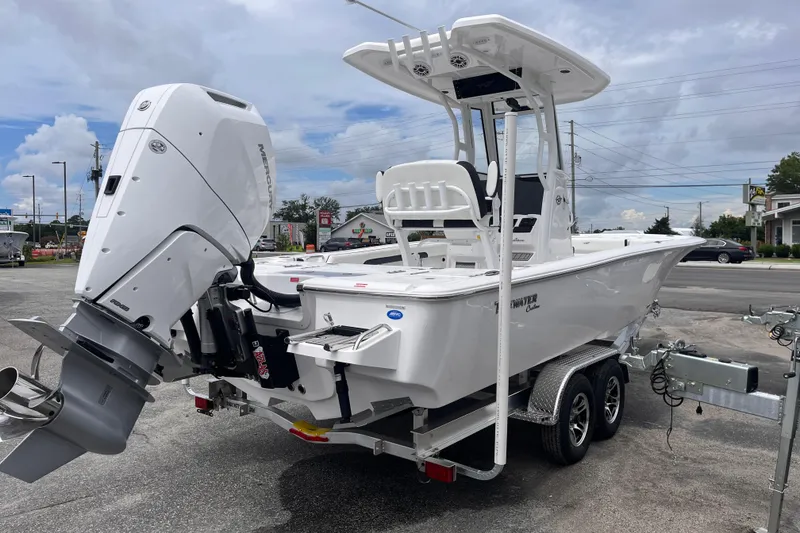 Slide: The Image of 2026 Tidewater 2500 Carolina Bay boat on trailer, featuring powerful outboard motor. - 4