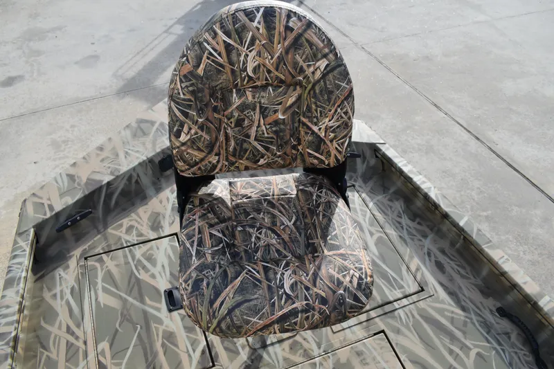 Slide: The Image of 2026 Lowe Roughneck RX1860 Tunnel Jet boat with camouflage seating and console design. - 14