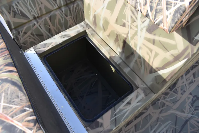 Slide: The Image of 2026 Lowe Roughneck RX1860 Tunnel Jet boat with camo pattern and storage compartments. - 17