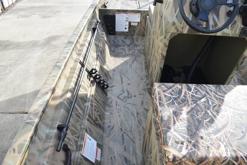 Slide: The Image of 2026 Lowe Roughneck RX1860 Tunnel Jet boat with camouflage seating and interior design. - 18