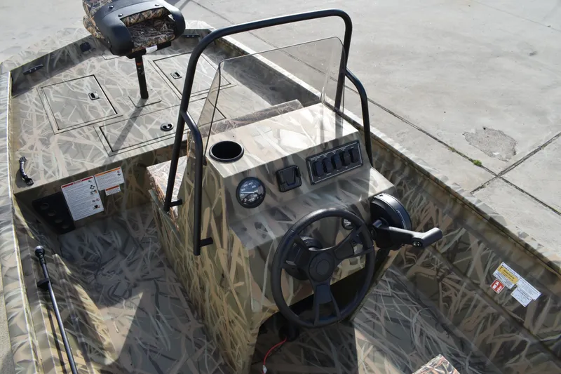 Slide: The Image of 2026 Lowe Roughneck RX1860 Tunnel Jet boat dashboard with steering wheel and controls. - 22