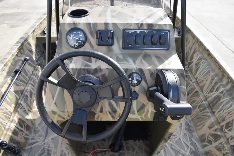 Slide: The Image of 2026 Lowe Roughneck RX1860 Tunnel Jet boat with camouflage design and steering console. - 23