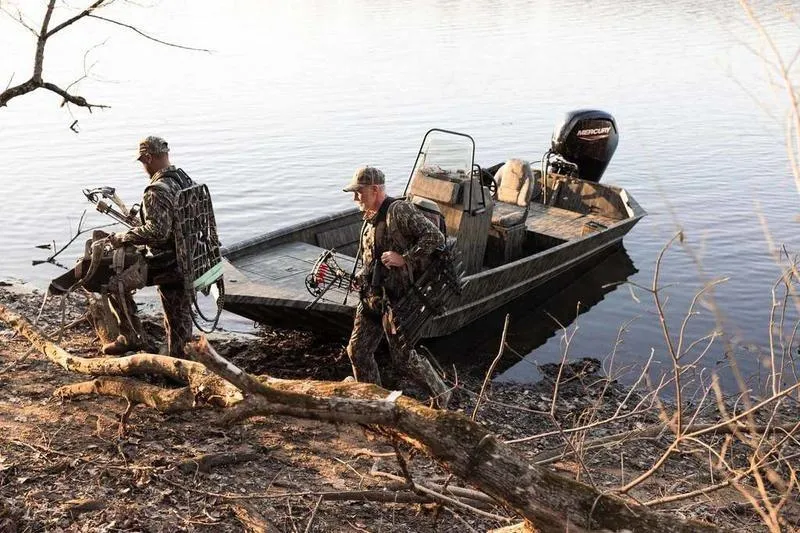 Slide: The Image of 2026 Lowe Roughneck RX1860 Tunnel Jet boat with camouflage design on a trailer. - 3