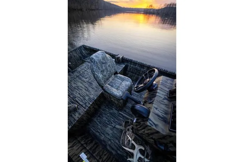 Slide: The Image of 2026 Lowe Roughneck RX1860 Tunnel Jet boat with camouflage design and jet engine detail. - 6