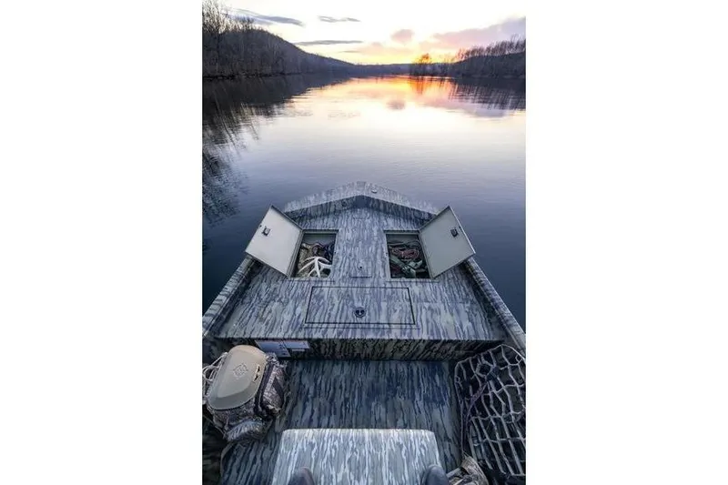 Slide: The Image of 2026 Lowe Roughneck RX1860 Tunnel Jet boat with camouflage design and powerful outboard motor. - 8