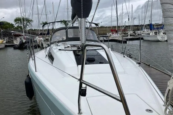 Slide: The Image of 2017 Hanse 315 sailboat docked in a marina, overcast sky, surrounded by other boats. - 10