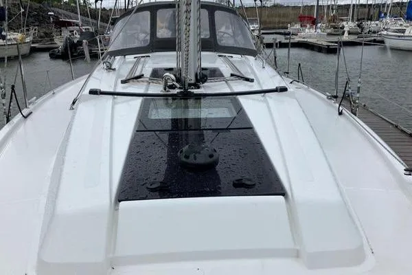 Slide: The Image of 2017 Hanse 315 sailboat deck view in marina, showcasing sleek design and modern features. - 11