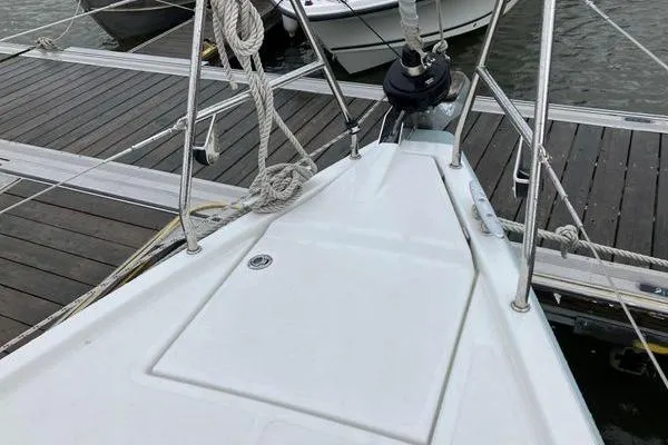 Slide: The Image of Bow of a 2017 Hanse 315 sailboat docked at a marina. - 12