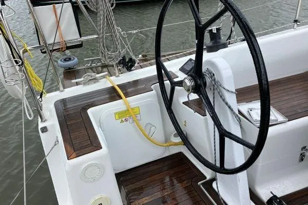 Slide: The Image of Steering wheel of a 2017 Hanse 315 sailboat with wooden deck details. - 15