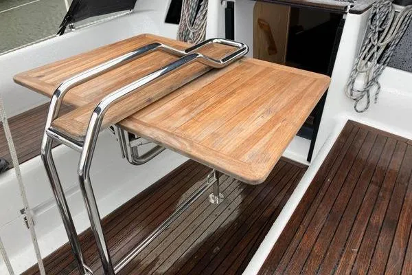 Slide: The Image of Wooden cockpit table on a 2017 Hanse 315 sailboat with stainless steel supports. - 20