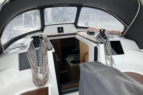 Slide: The Image of Interior view of 2017 Hanse 315 sailboat cockpit with ropes and seating. - 21