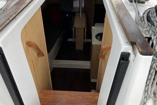 Slide: The Image of Interior view of 2017 Hanse 315 sailboat cabin entrance with wooden steps and handrails. - 22